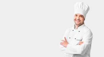 Chef's Career. Cook Guy Standing Crossing Hands Posing Over White Background In Studio. Panorama With Free Space photo