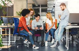 Team Brainstorming at Contemporary Office Table. Multinational team gathered around a sleek office table, actively brainstorming with enthusiasm and creative synergy filling the room. photo