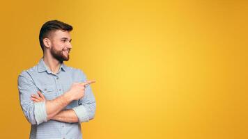 A man with a beard points at something, indicating a direction or highlighting a specific item, panorama with copy space photo