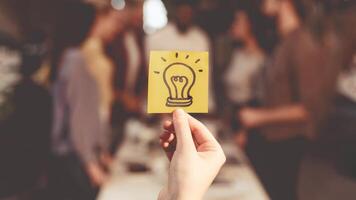 New idea concept. Business team discussing startup project, picture of light bulb on foreground photo