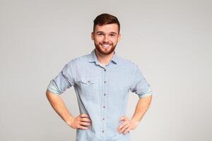 Portrait of smiling guy with hands on hips on beige background, panorama, copy space photo