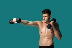 A man is standing in front of a vibrant green background, firmly holding two dumbbells in his hands. He appears focused and determined as he engages in strength training exercises. photo