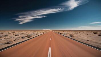 An empty road in the desert with clouds in the sky photo