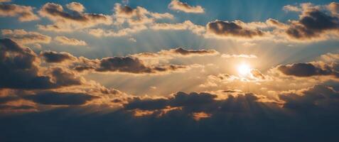 Sun rays shining through clouds in the sky photo