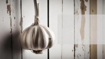 Close up monochromatic image with garlic hanging on a wall featuring ample copy space. photo