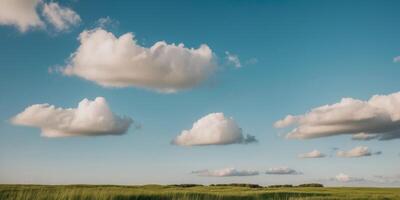 A field with some clouds in the sky photo