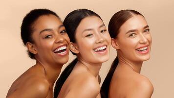 Skin And Body Care. Three Multiethnic Women Posing Smiling To Camera Standing Over White Background. Studio Shot, Panorama photo