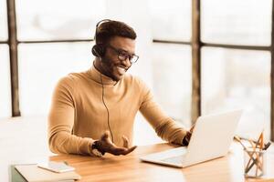 Call Center Service. Smiling black customer support agent talking with client. Copy space photo