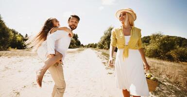 Finally, Outdoor. Family Of Three Walking Outside, Father Carrying Daughter Having Fun On Summer Day In Countryside. photo