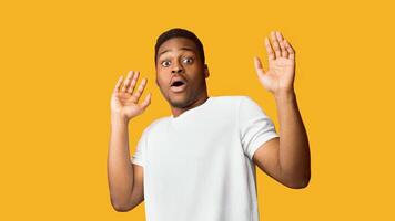 I'm Afraid. Scared black man making frightened gesture with his palms, trying to defend himself, panorama, copyspace photo