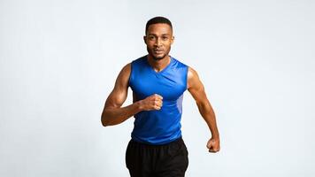 Running Competition. Confident black sportsman running, looking at camera, yellow background. Panorama, copyspace photo