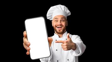 Excited Cook Man Showing Phone Empty Screen Recommending Restaurant Food Delivery App Service Standing On Black Studio Background. Panorama, Mockup photo