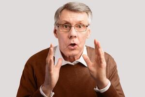 Shocked Elderly Man Looking At Camera Posing Over Gray Studio Background. Don't Do It, Warning Concept photo