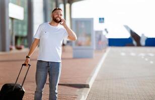 Call taxi. Man arriving at airport and ordering car, travelling alone, copy space photo