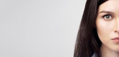 Portrait Of Woman Face Looking At Camera Over White Studio Background. Human Cloning And ID Data. Closeup photo