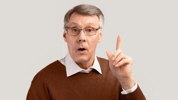 Idea. Elderly Gentleman Having Eureka Moment Pointing Finger Up Posing Over Gray Background. Panorama, Studio Shot photo