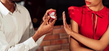 Black Millennial Girl Rejecting Saying No To Boyfriend's Marriage Proposal Refusing To Take Engagement Ring In Restaurant photo