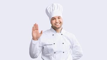Hello, I'm Chef. Professional Cook Man Waving Hand Smiling To Camera Standing Over White Studio Background. Panorama photo