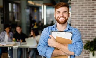 Student lifestyle. Happy student posing in library with classmates on background, free space photo