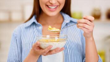 Dieting Concept. Girl Eating Yogurt With Flakes For Breakfast, Crop photo