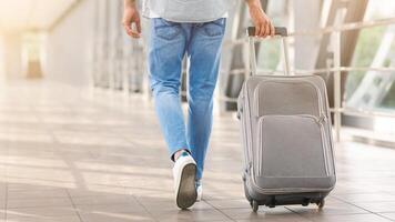 Time To Flight. Unrecognizable Man Walking With Suitcase In Airport, Going To Boarding Gate, Cropped Image, Rear View photo
