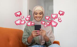 The image shows a smiling woman wearing a hijab and sitting on an orange couch. She is using a smartphone and a number of social media icons are surrounding her photo