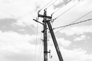Power electric pole with line wire on dark background close up photo