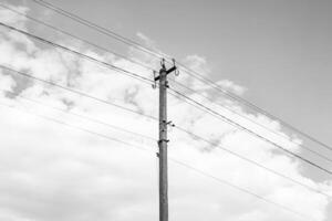 Power electric pole with line wire on dark background close up photo