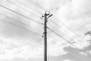 Power electric pole with line wire on dark background close up photo
