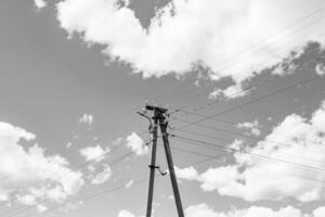 Power electric pole with line wire on light background close up photo