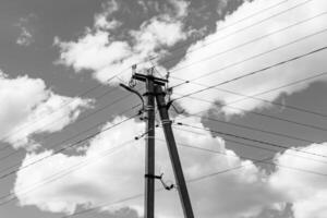 Power electric pole with line wire on light background close up photo