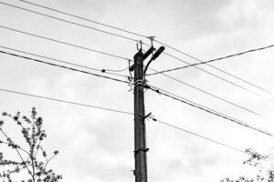 Power electric pole with line wire on dark background close up photo