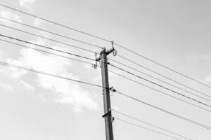 Power electric pole with line wire on dark background close up photo