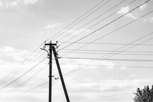 Power electric pole with line wire on dark background close up photo