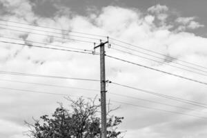 Power electric pole with line wire on dark background close up photo