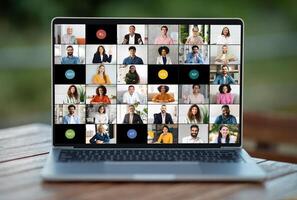 A laptop screen showing a group of individuals engaged in a virtual meeting or conference. The people on the screen appear to be conversing or collaborating on a project remotely. photo