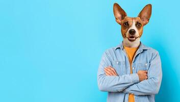 A man stands casually with his arms crossed, displaying a playful expression. His head has been replaced by that of a dog, creating a whimsical and entertaining effect. The background is blue photo