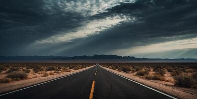 An empty road in the desert with storm clouds photo