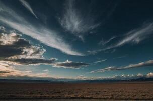 A road in the middle of a desert with clouds in the sky photo