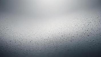 Raindrops on glass background with light photo
