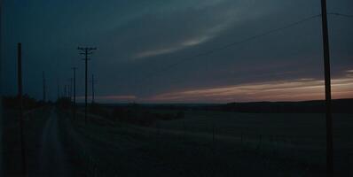 A dark sky with clouds and power lines photo
