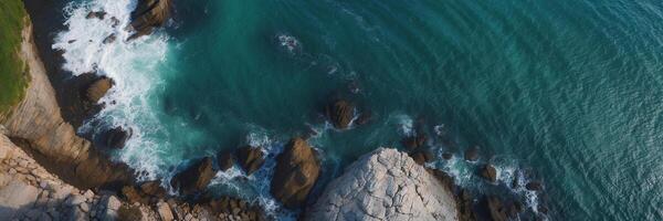 An aerial view of the ocean and rocks photo