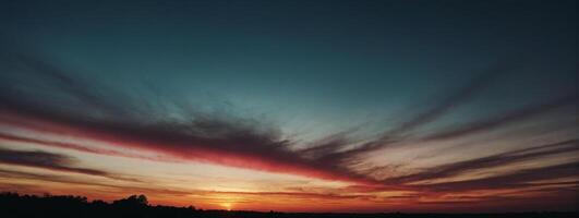 A sunset with clouds and a red sky photo