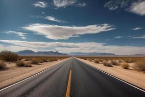 An empty road in the desert with a blue sky photo
