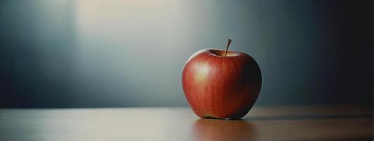 An apple sitting on a table in front of a blurry background photo