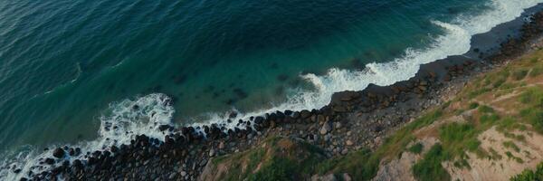 An aerial view of the ocean and rocks photo