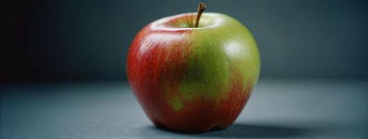 A red and green apple sitting on a table photo
