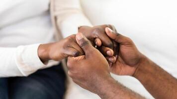 A close-up image of a couples hands clasped together, showcasing their love and connection. photo
