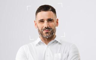 A man poses with a facial recognition overlay, showcasing modern technology's integration with human expression. photo