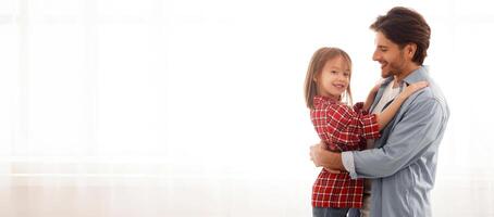 Smiling girl hugging her loving dad over white background at home, copy space photo